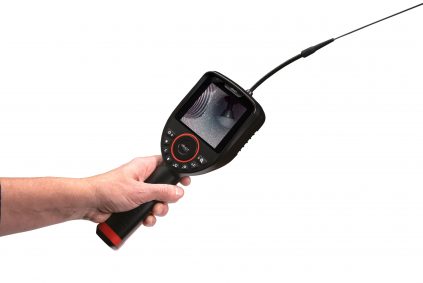 hand seizing a black and red borescope with a clear view of the screen