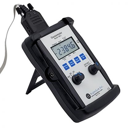 gaussmeter displayed on a stand, showing readings.