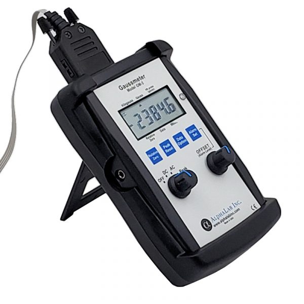 gaussmeter displayed on a stand, showing readings.